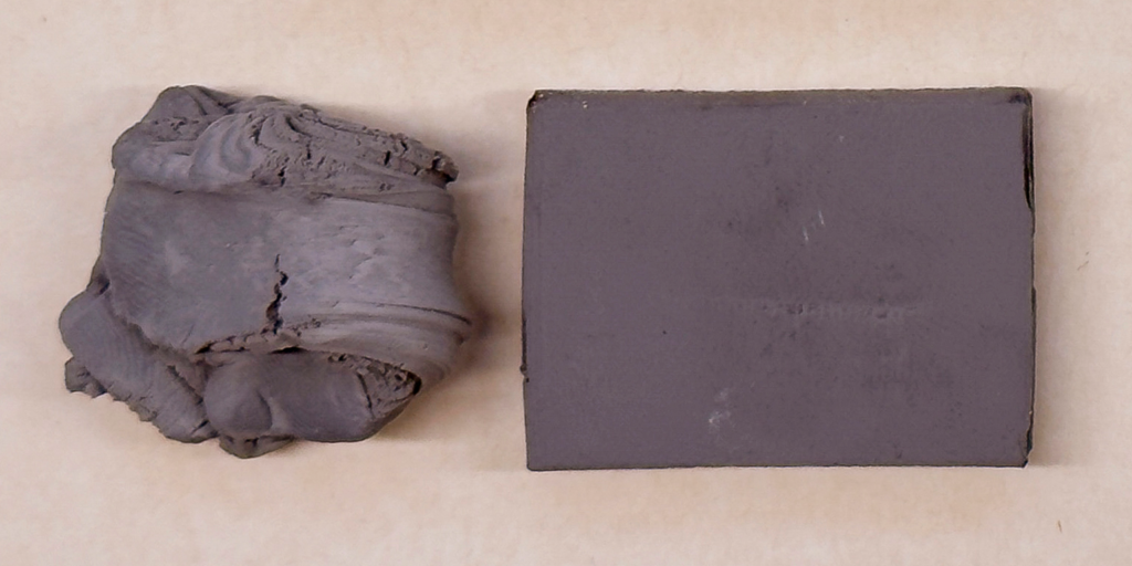 Photograph of a kneadable eraser on a paper background.